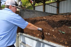 Max Alff examines a cross section of compost.