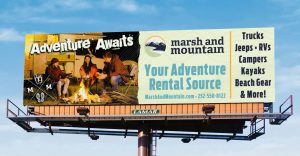 Marsh and Mountain billboard reads "Adventure Awaits. Your adventure rental source." 