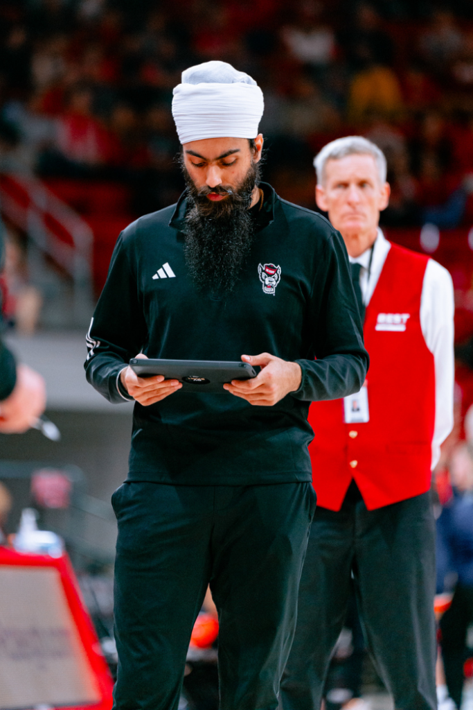 Darasjot Hothi with the coaching staff of NC State women's basketball.